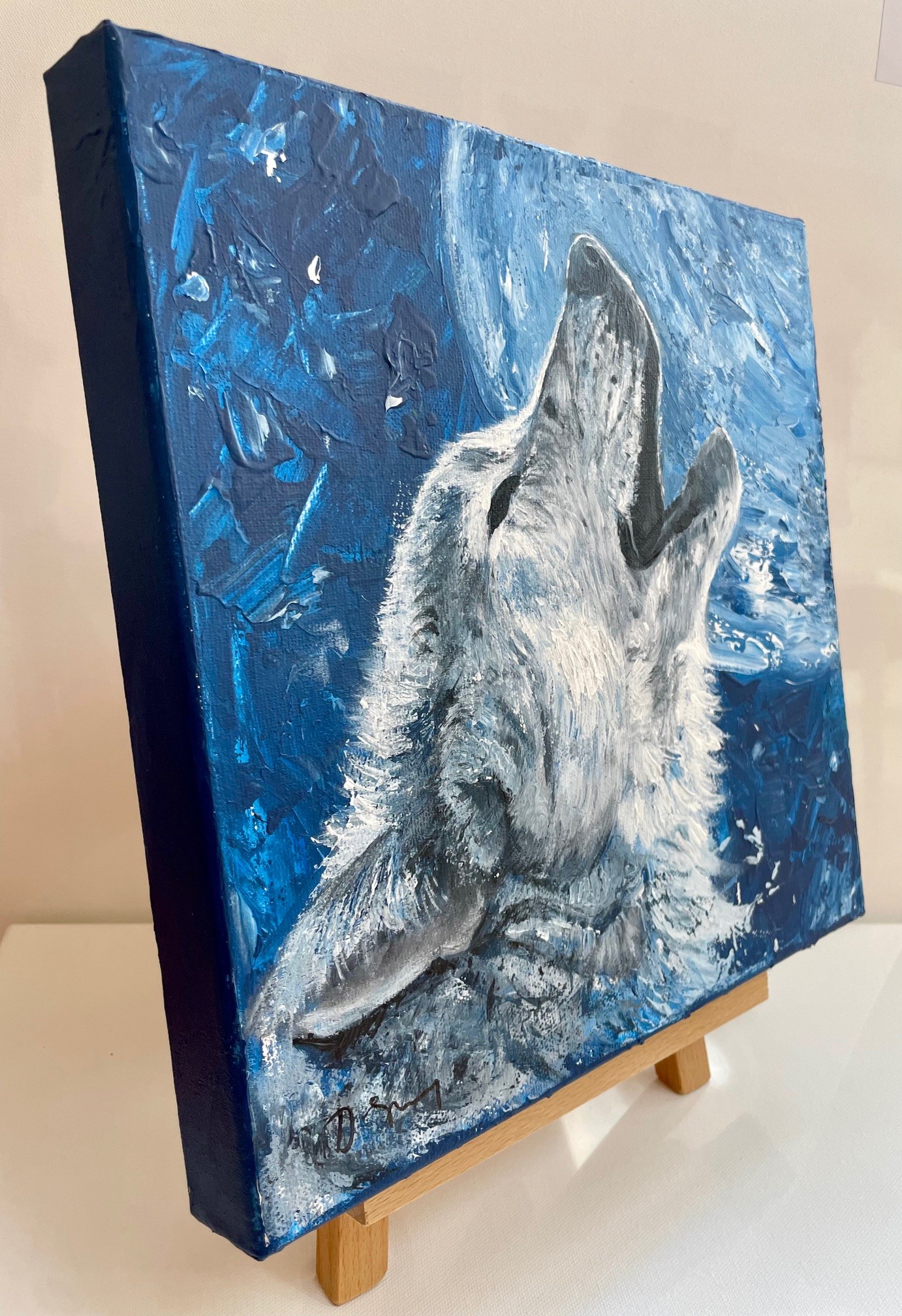 Side view of a painting of a howling wolf, by Debbie Storey