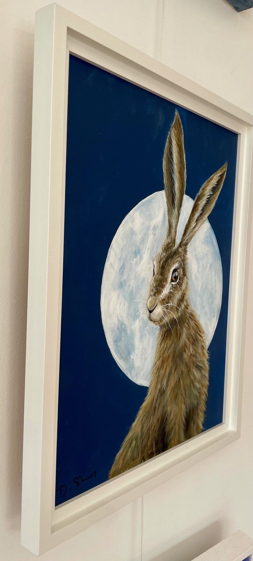 Painting of pretty hare in front of the moon