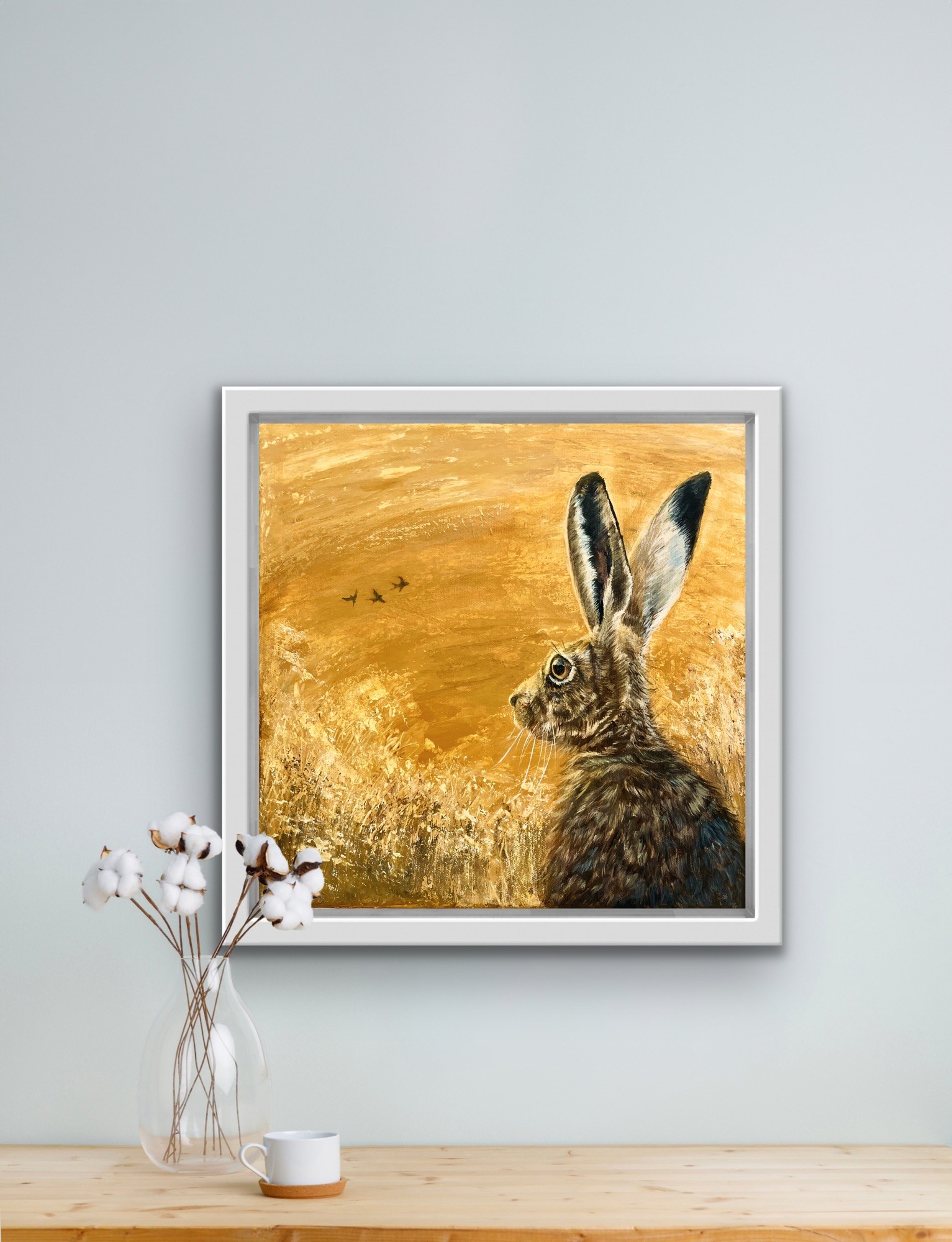 Painting of a hare on yellow background, hanging n a wall, by Debbie Storey